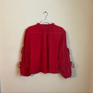 Red puff sleeve top with bows